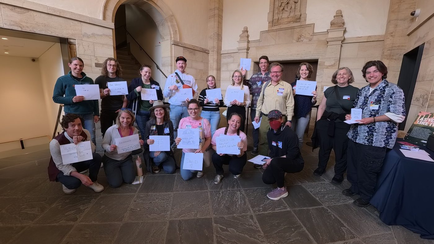 Mending participants smile and hold up handwritten notes to people they care about